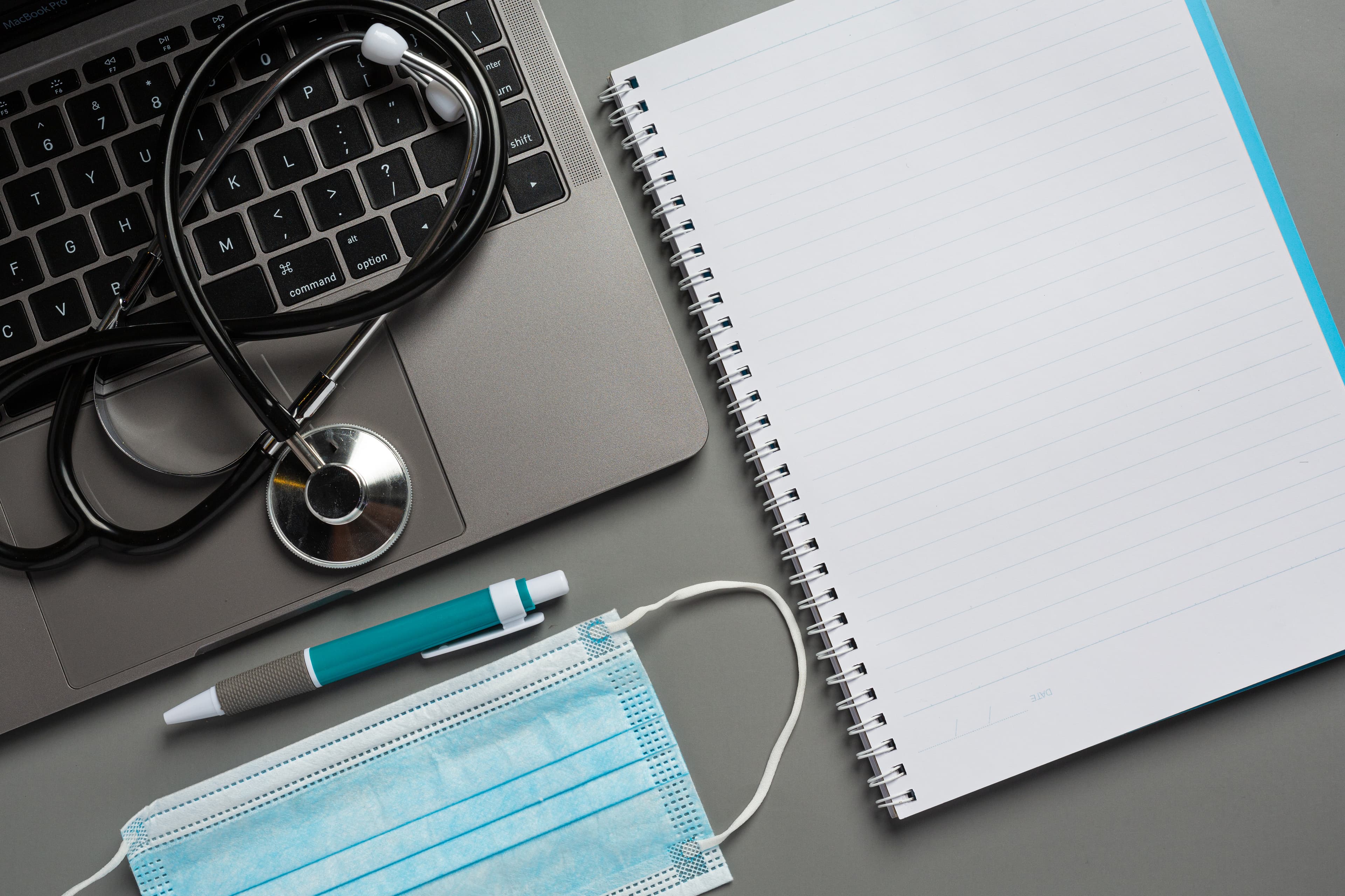 Background image of some doctor utensils and a notebook